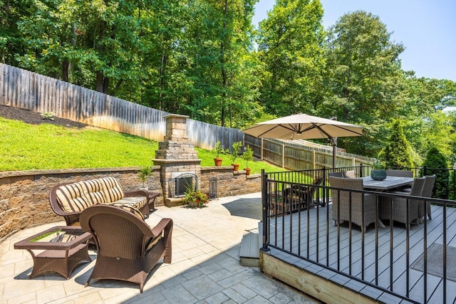 view of patio featuring an outdoor stone fireplace