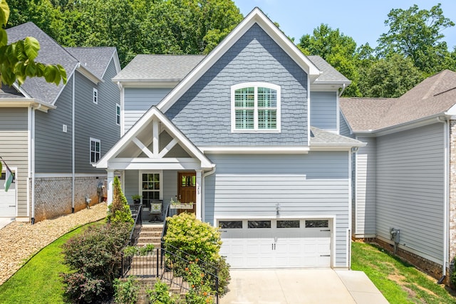 view of front of property featuring a garage and covered porch