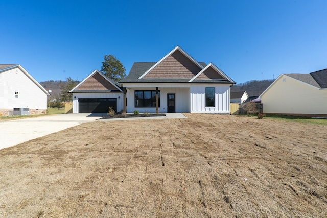 view of front of house featuring a garage and central AC