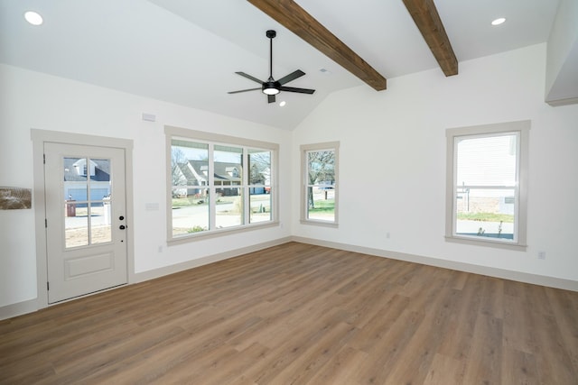 unfurnished living room featuring lofted ceiling with beams, wood-type flooring, and ceiling fan