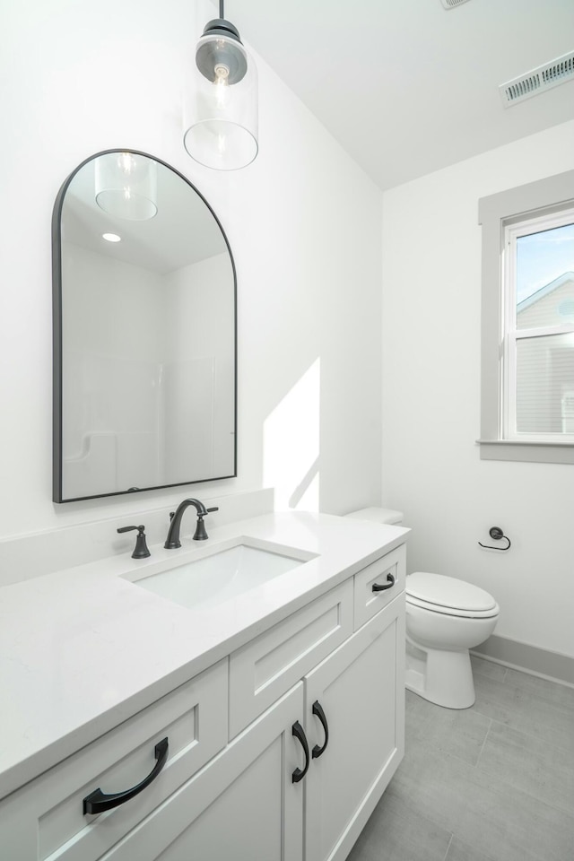 bathroom with vanity, toilet, and walk in shower