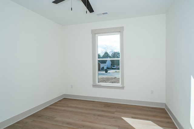 empty room with light hardwood / wood-style flooring and ceiling fan