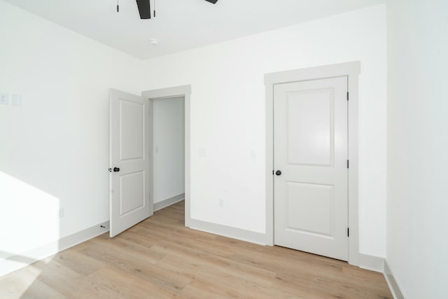 unfurnished bedroom featuring ceiling fan and light wood-type flooring