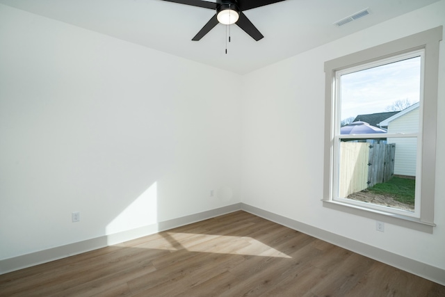 unfurnished room with ceiling fan and hardwood / wood-style floors