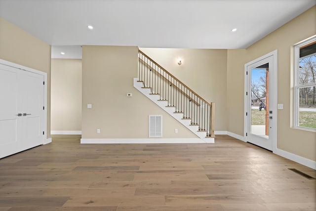 foyer featuring recessed lighting, visible vents, baseboards, stairway, and light wood-type flooring