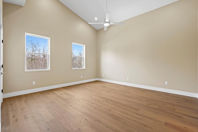 spare room featuring baseboards, ceiling fan, and light wood-style floors