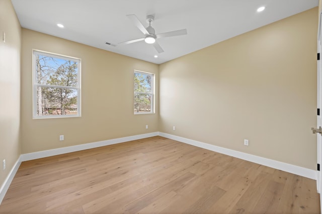 unfurnished room featuring light wood-style floors, baseboards, and recessed lighting