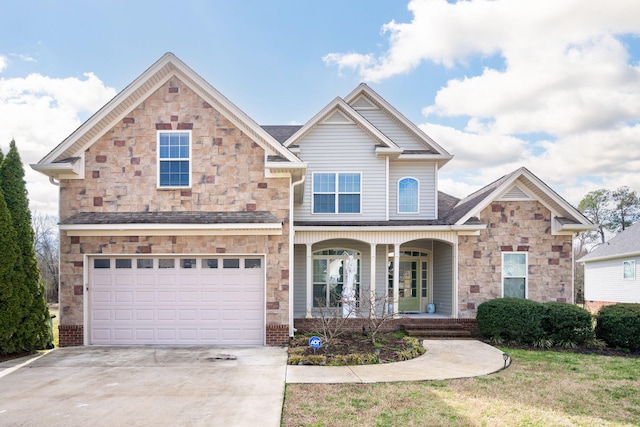 craftsman house featuring a garage, covered porch, and a front yard