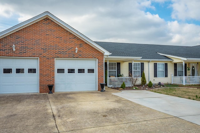 ranch-style home featuring covered porch and a garage