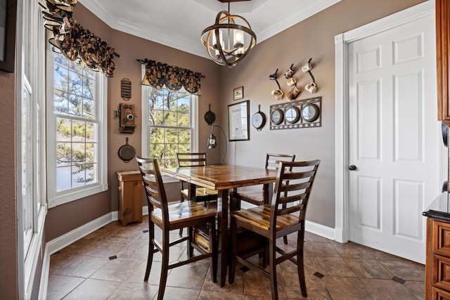 dining area featuring ornamental molding, a chandelier, and baseboards