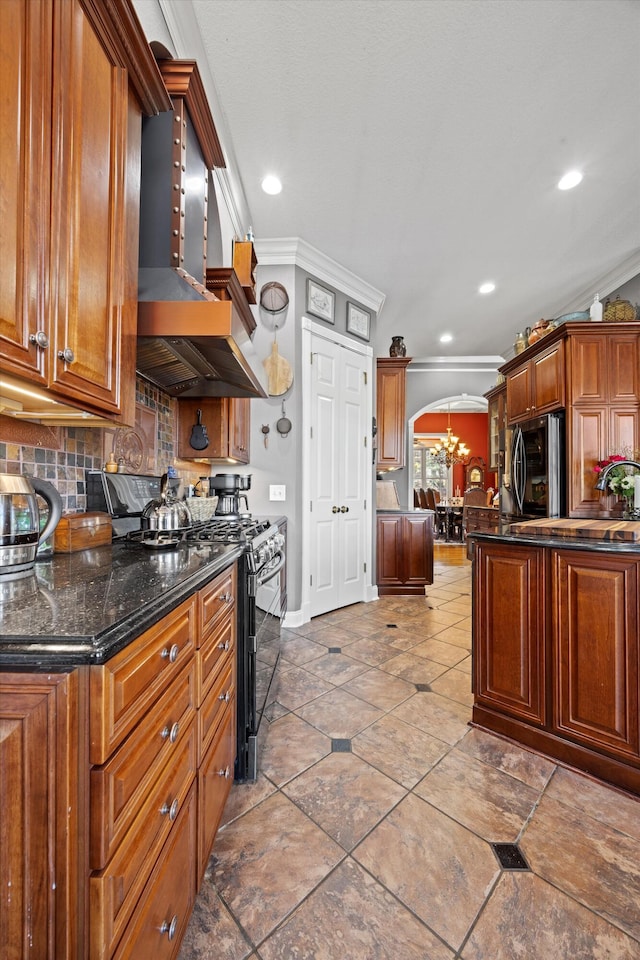 kitchen with arched walkways, black stove, ornamental molding, smart refrigerator, and custom range hood