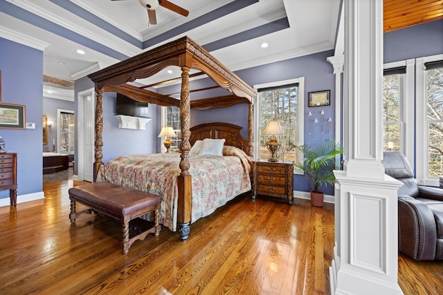 bedroom with ornate columns, baseboards, wood finished floors, and crown molding