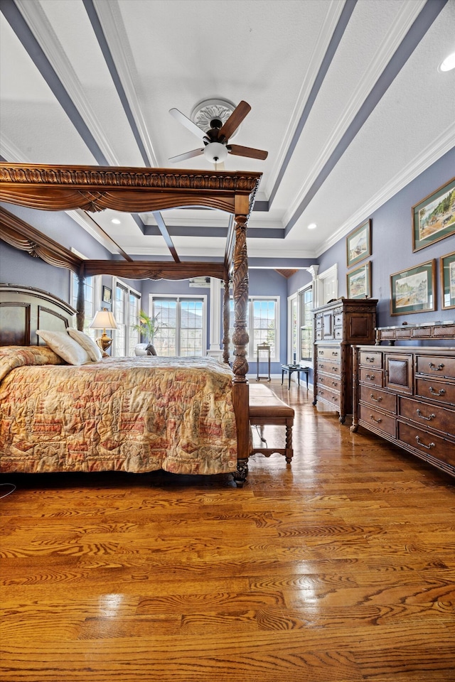 bedroom with ornamental molding, wood finished floors, and recessed lighting