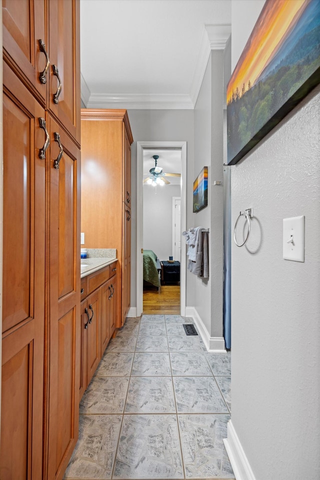 bathroom with baseboards, ornamental molding, ceiling fan, and tile patterned flooring