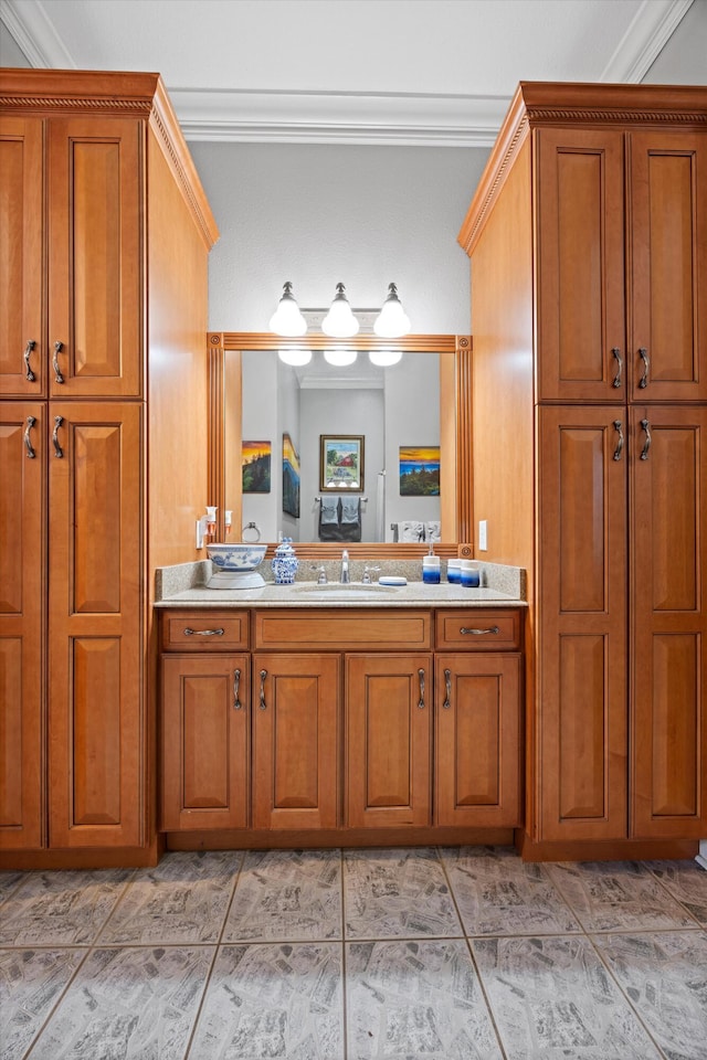 bathroom with tile patterned floors, crown molding, and vanity