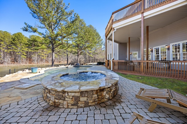 view of patio / terrace with fence, a fenced in pool, and an in ground hot tub