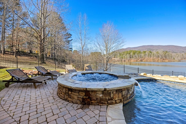 view of pool featuring a fire pit, a patio area, fence, and a water and mountain view