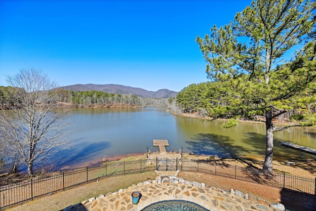 view of water feature featuring fence and a mountain view