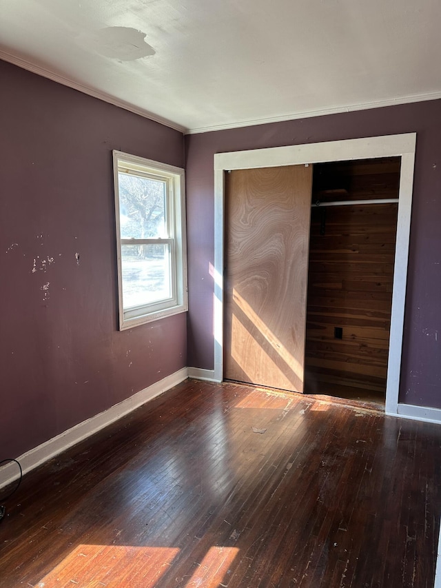 unfurnished bedroom with a closet and hardwood / wood-style floors