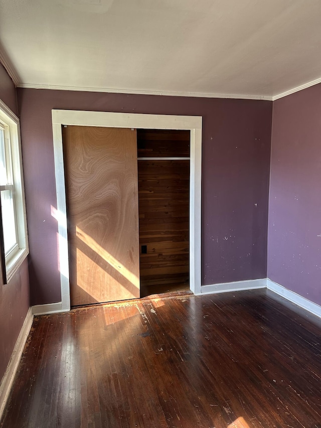 unfurnished bedroom with a closet and hardwood / wood-style floors