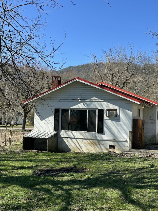 rear view of house with a yard