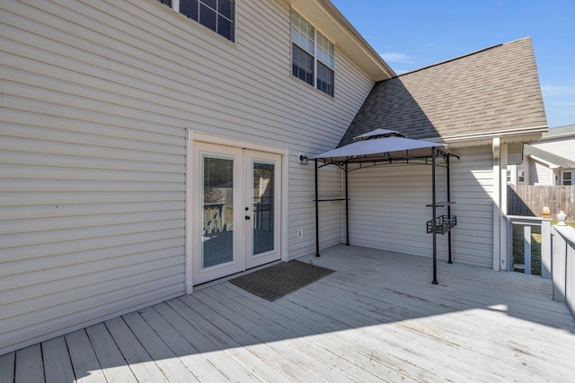 wooden terrace with a gazebo and french doors