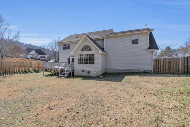 rear view of property with a deck and a lawn