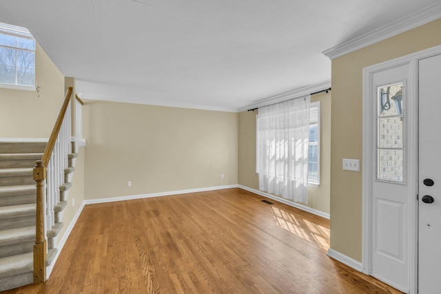 foyer featuring crown molding and wood-type flooring