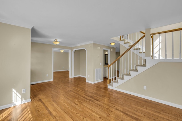 interior space featuring crown molding and wood-type flooring