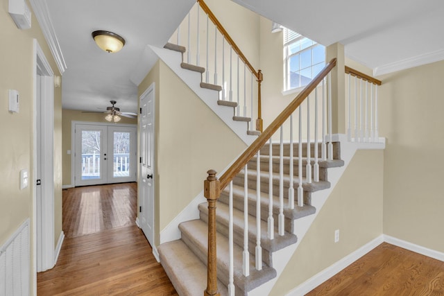 stairway featuring hardwood / wood-style floors, ornamental molding, and french doors