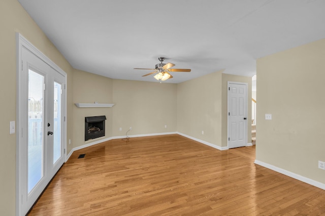 unfurnished living room featuring ceiling fan and light hardwood / wood-style floors