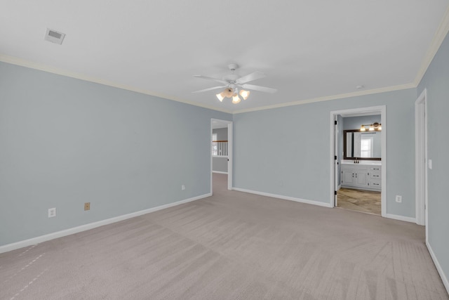 unfurnished bedroom with ornamental molding, connected bathroom, light colored carpet, and ceiling fan