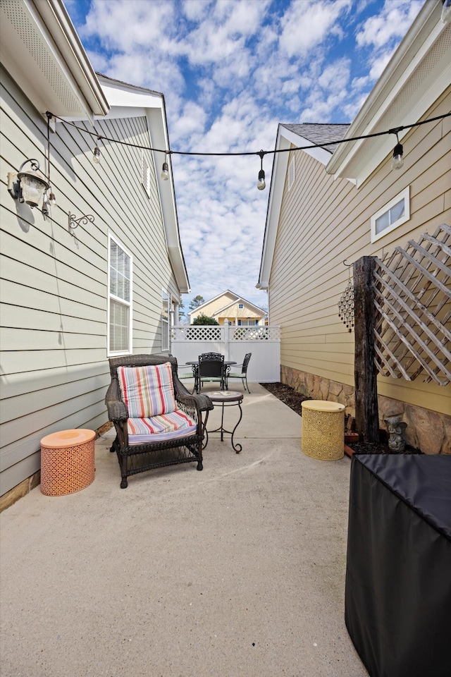 view of patio / terrace featuring fence