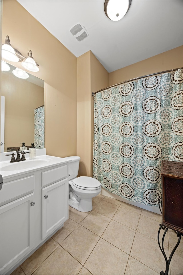 bathroom with tile patterned flooring, visible vents, vanity, and toilet