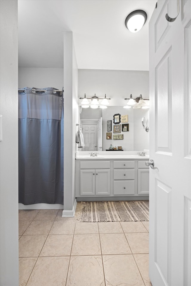 full bathroom featuring tile patterned floors, a sink, a shower with shower curtain, and double vanity