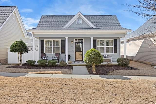 bungalow-style house with a shingled roof and covered porch