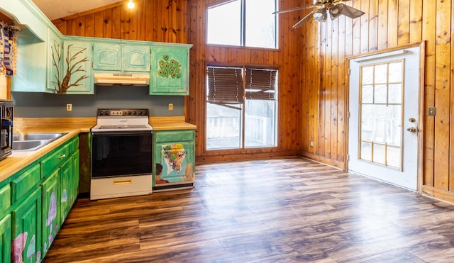 kitchen featuring lofted ceiling, white electric range oven, under cabinet range hood, and wood walls