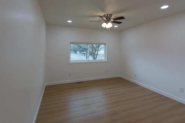 unfurnished room featuring ceiling fan and light wood-type flooring