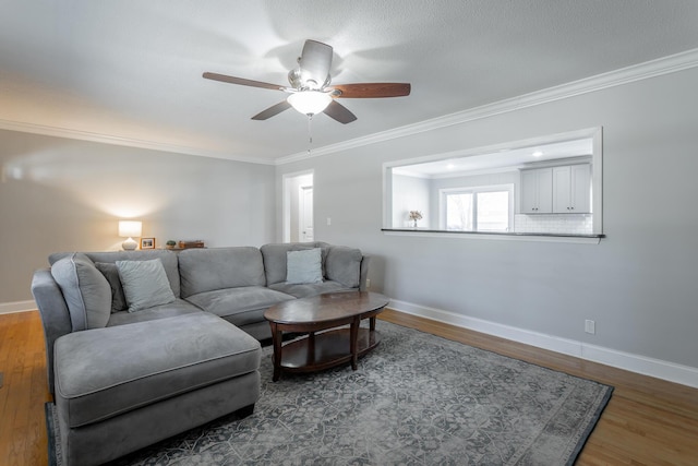 living area featuring baseboards and wood finished floors