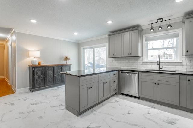 kitchen featuring dark countertops, dishwasher, gray cabinets, a peninsula, and a sink