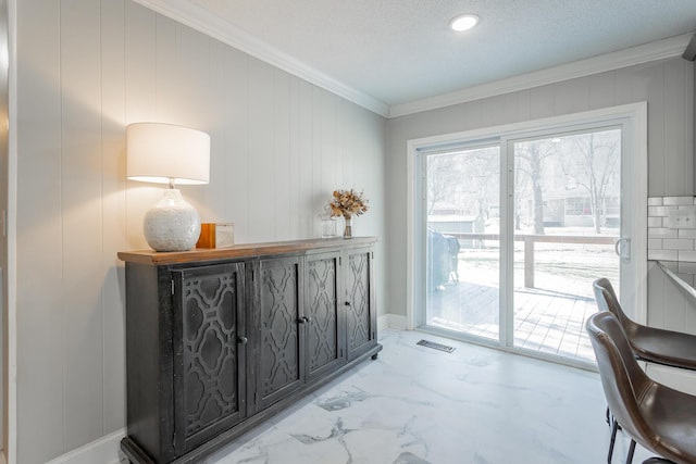 home office with visible vents, marble finish floor, and ornamental molding