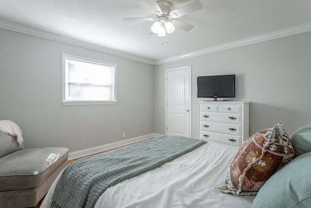 bedroom with a ceiling fan, crown molding, and baseboards