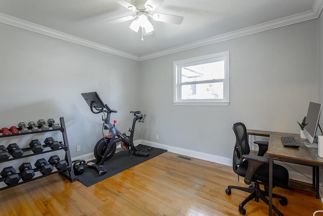 office space featuring wood finished floors, baseboards, visible vents, ceiling fan, and ornamental molding