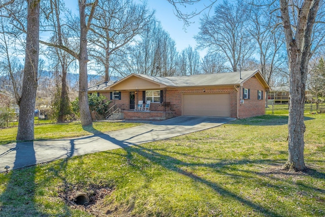 single story home featuring a porch, an attached garage, a front lawn, concrete driveway, and brick siding