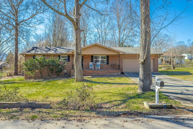 ranch-style home featuring driveway, a front lawn, brick siding, and an attached garage