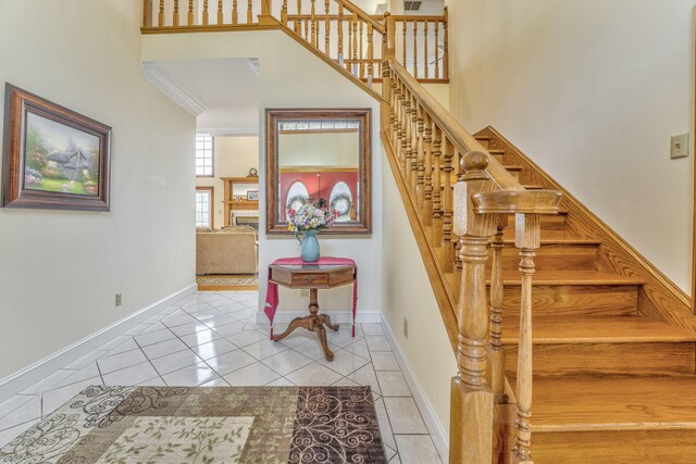 815 Battlefield Park Dr, Dalton, GA 30720 - staircase with crown molding, a towering ceiling, and tile patterned floors