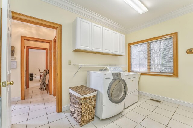 815 Battlefield Park Dr, Dalton, GA 30720 - clothes washing area featuring cabinets, ornamental molding, light tile patterned flooring, and washer and clothes dryer