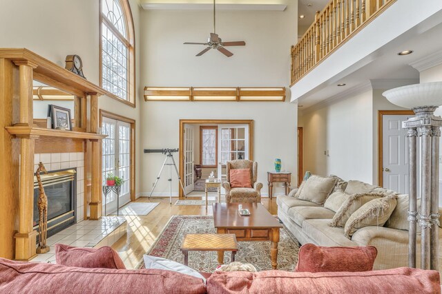 815 Battlefield Park Dr, Dalton, GA 30720 - living room with ornamental molding, ceiling fan, a fireplace, light hardwood / wood-style floors, and a high ceiling