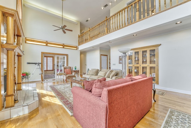 815 Battlefield Park Dr, Dalton, GA 30720 - living room featuring ceiling fan, ornamental molding, light hardwood / wood-style flooring, and a towering ceiling