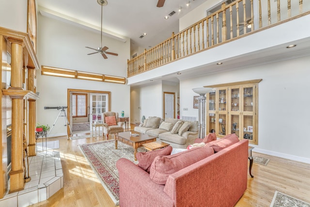 815 Battlefield Park Dr, Dalton, GA 30720 - living room featuring a towering ceiling, ceiling fan, and light wood-type flooring